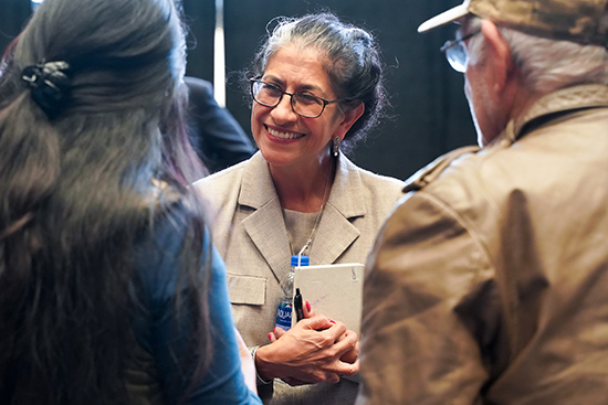 Maria Echaveste speaks with community members following her conversation on