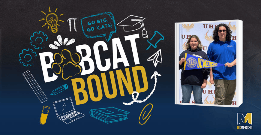 Two people with a banner, blue and yellow graphic reading