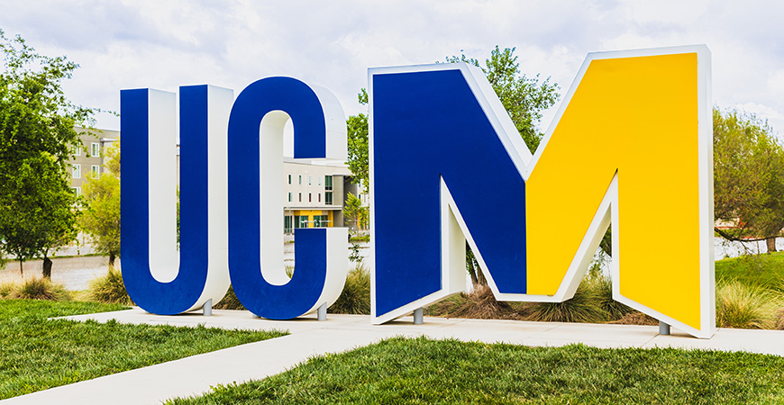 UCM letters in blue and yellow on Pavilion lawn